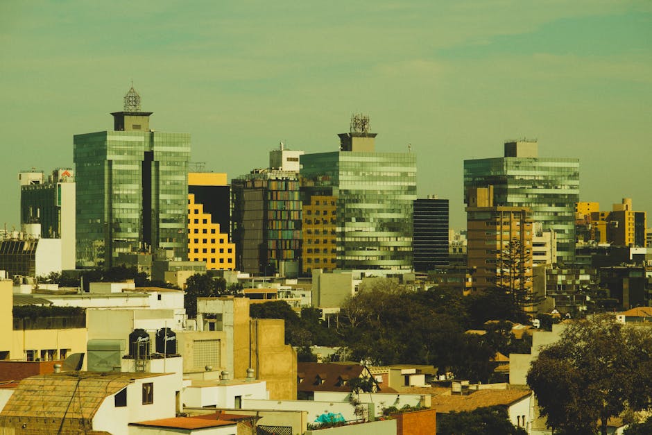 Aerial view of a modern cityscape with tall buildings and urban skyline.