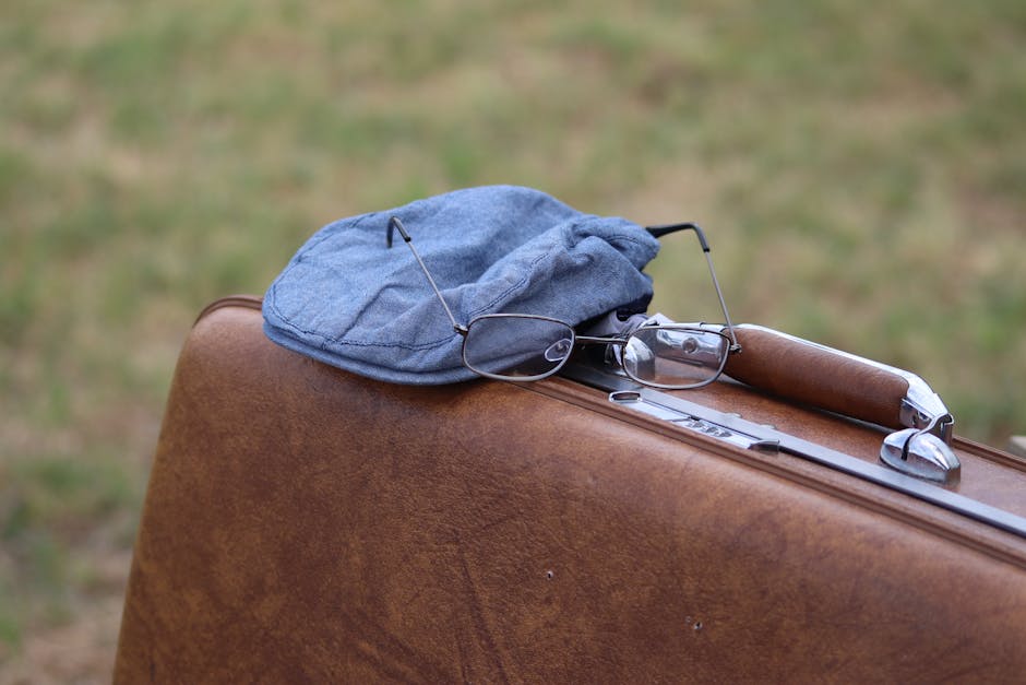 A classic scene featuring a vintage suitcase with a hat and glasses, evoking travel memories.